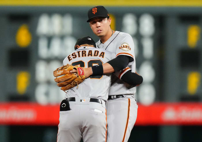 SF Giants infielders Wilmer Flores and Thairo Estrada embrace. (2022)